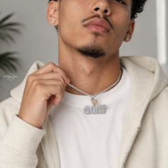 iced out goat pendant shown indoors modeled in natural environment