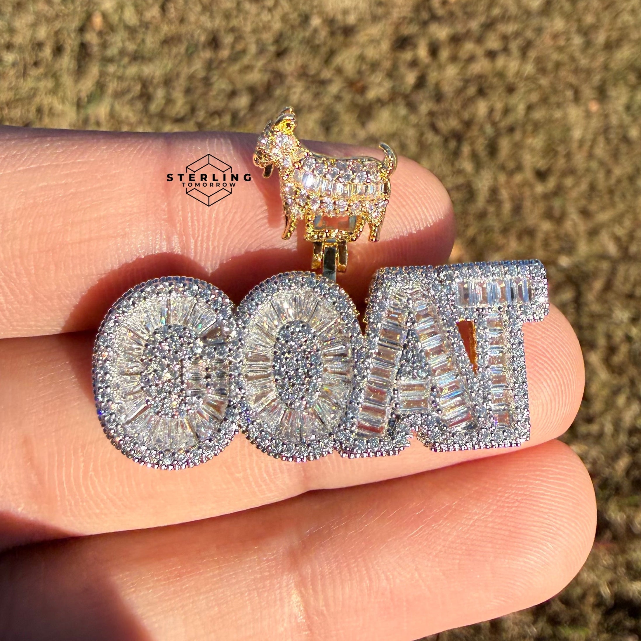 iced out goat pendant shown outside in sunlight